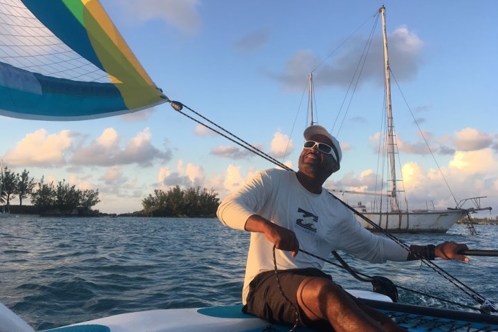 a man sitting in a boat on a body of water