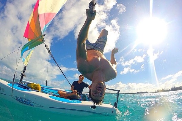 a man flying a kite in a boat on the water