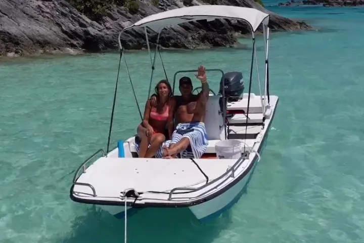 a person sitting on a boat in a body of water