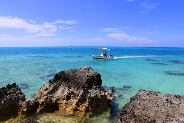 a rocky island in the middle of a body of water