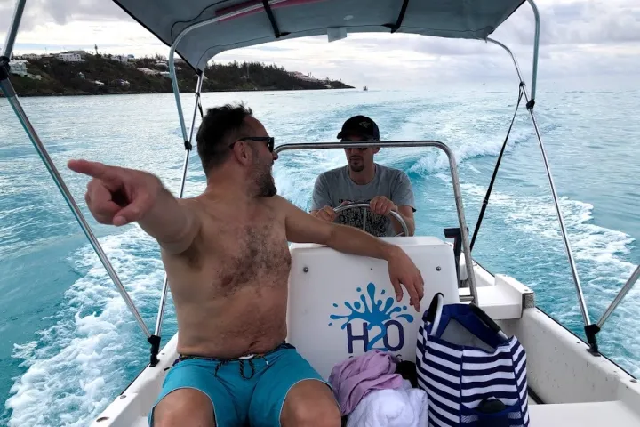 a person sitting in a boat on a body of water