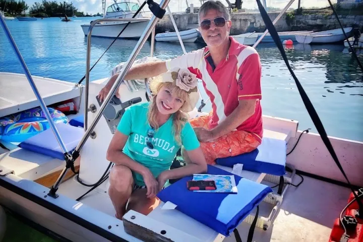 a person sitting in a boat on a body of water