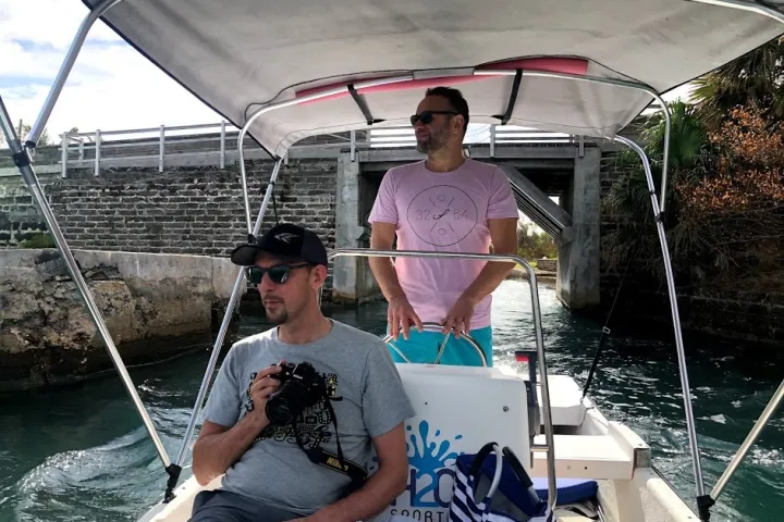 a man sitting in a boat on a body of water