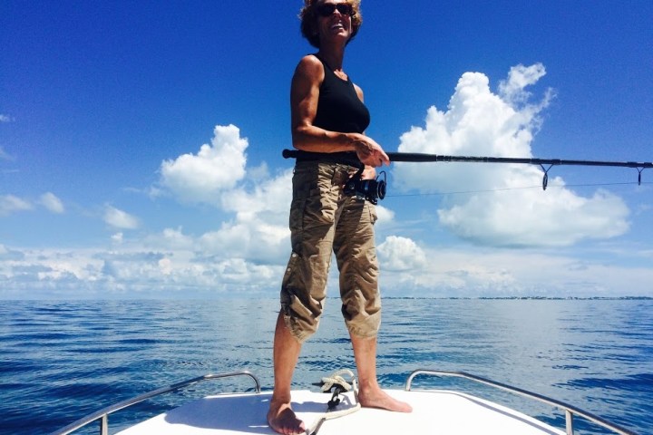 a man riding on the back of a boat in the water