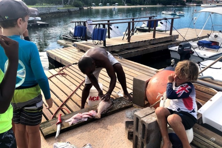 a woman sitting on a dock near the water