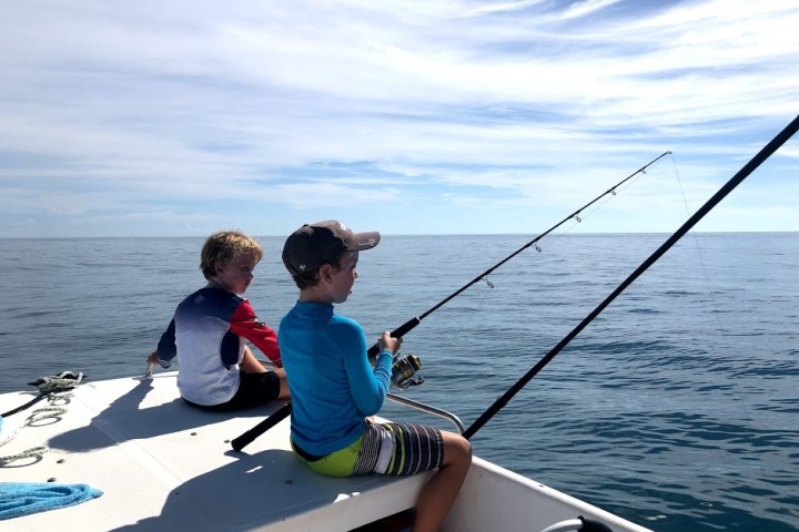 a group of people in a boat on a body of water