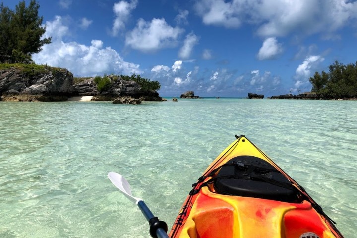 a person standing next to a body of water
