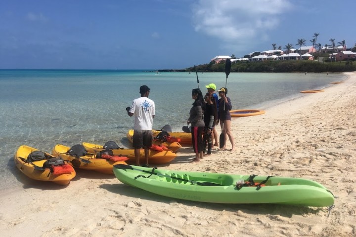 a group of people sitting at a beach
