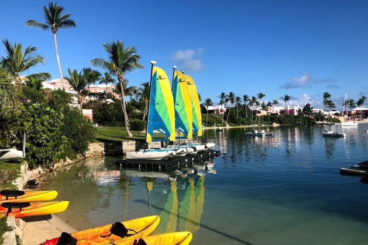 a yellow boat sitting on top of a body of water