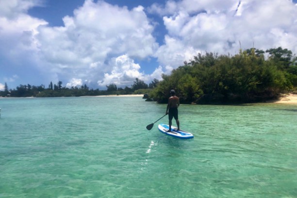 a person riding a surf board on a body of water