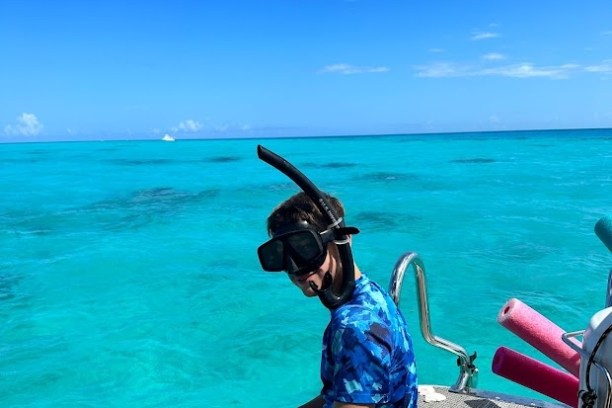 a person sitting on a beach near a body of water
