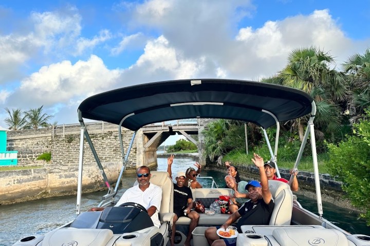 a group of people sitting around a car