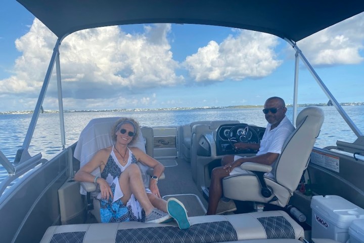 a man and a woman sitting on a boat in the water